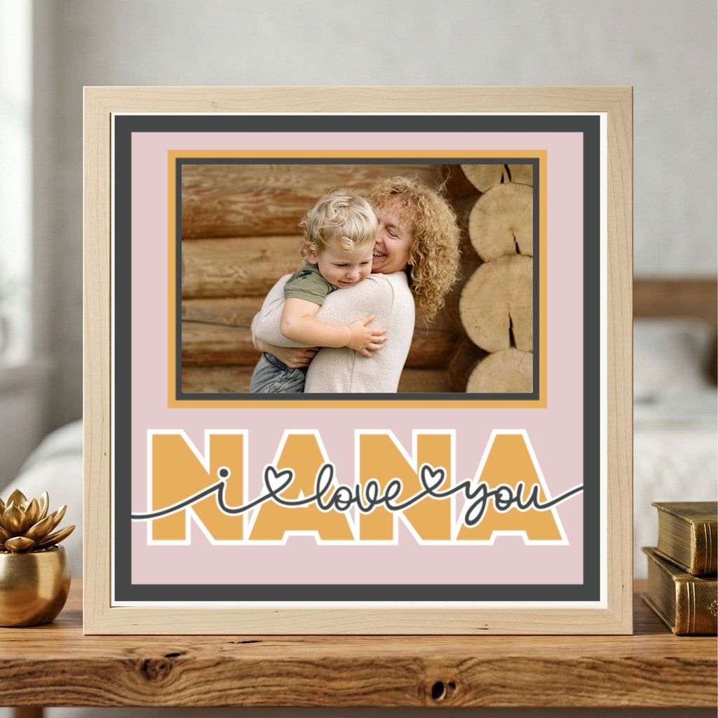 Framed photo of a woman holding a child with 'Nana I love you' text on a pink background.